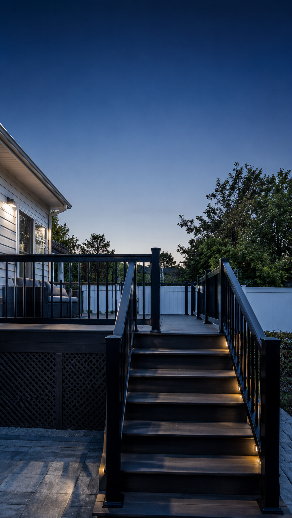 Custom deck with lit stairs at dusk