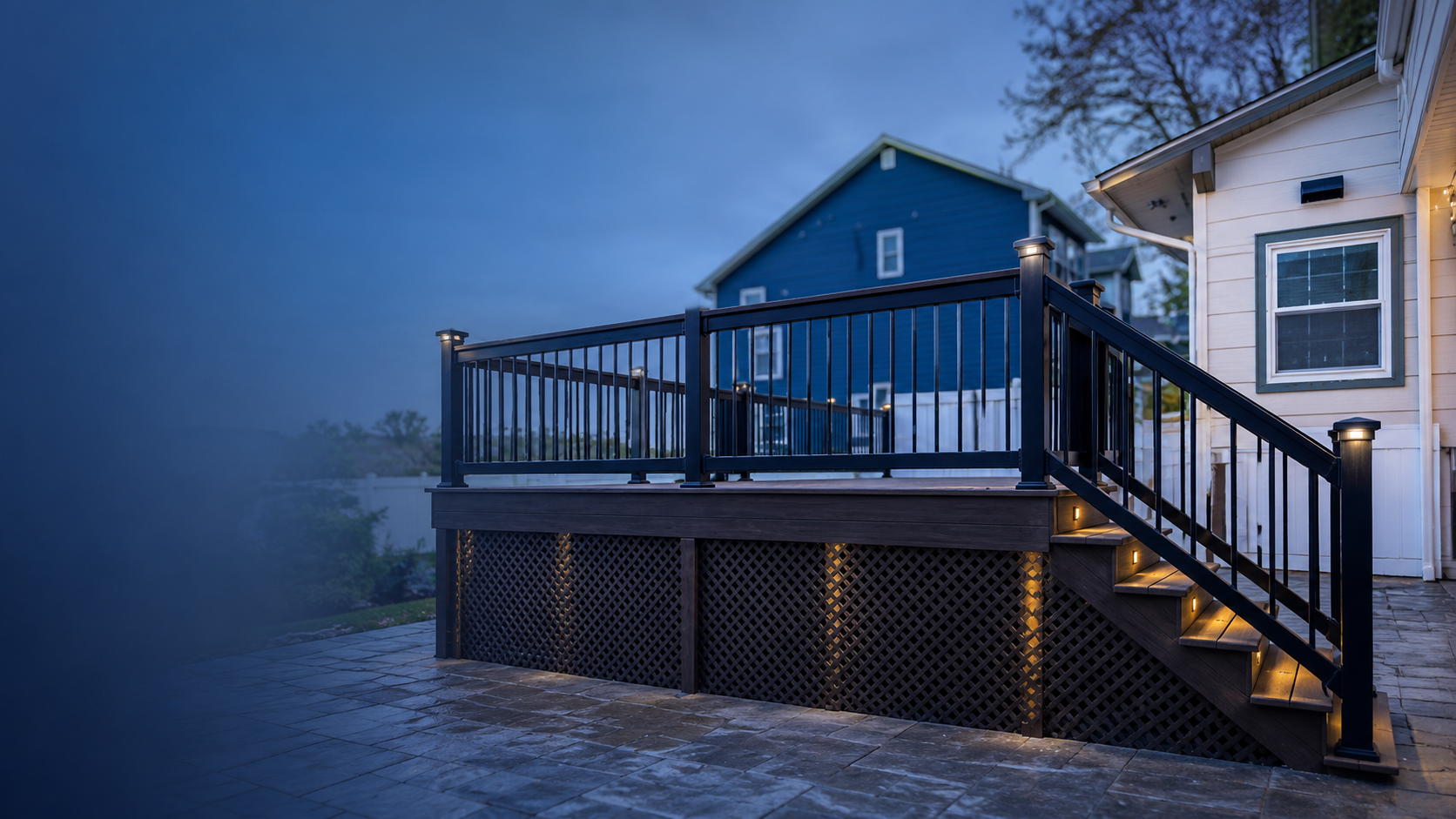 Wide deck with black metal railing and lattice skirt
