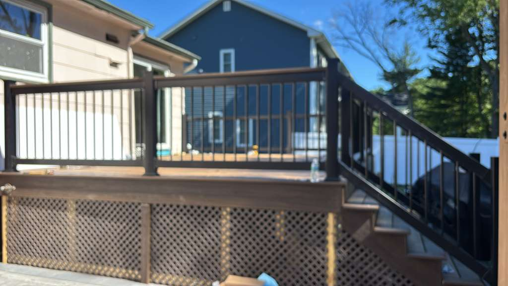 Daytime deck with railing overlooking yard